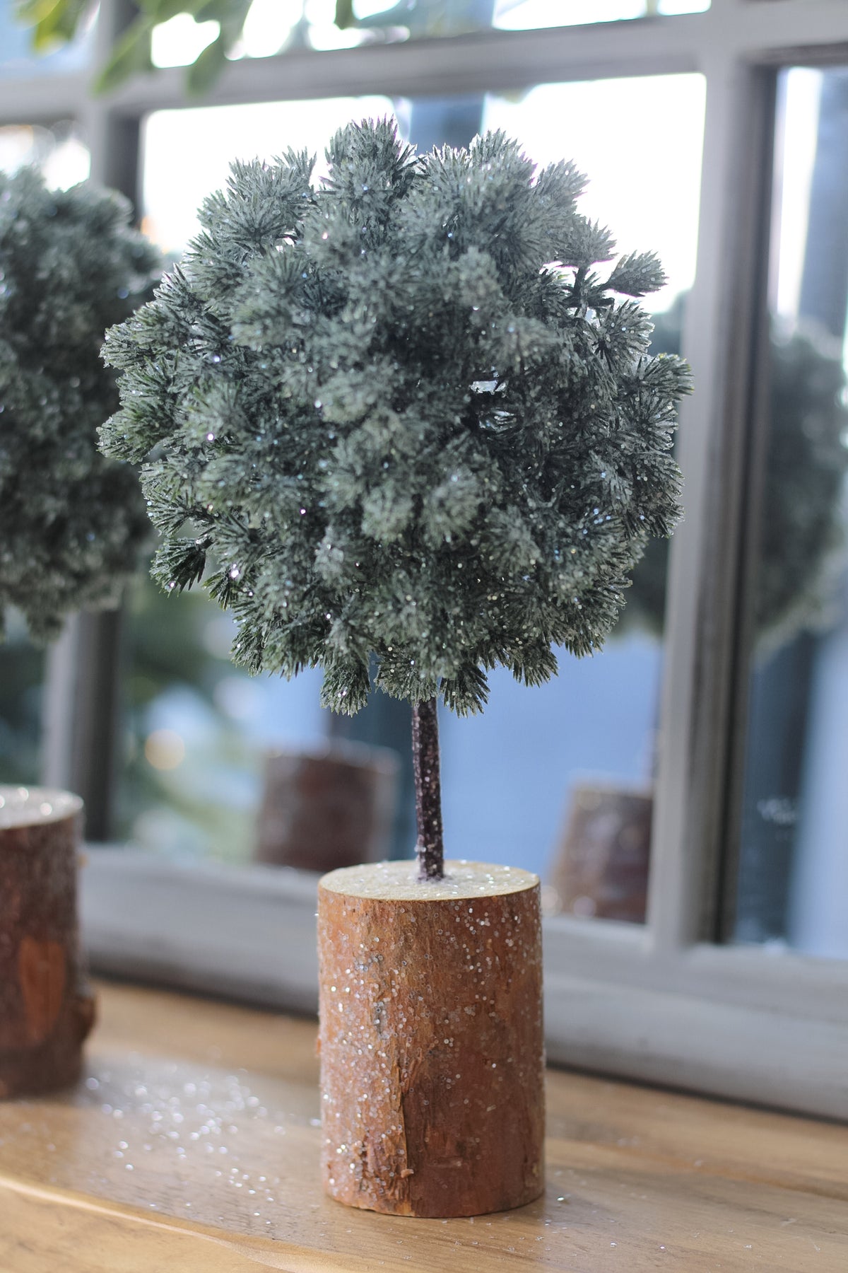rounded green fir tree on wooden base