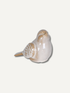 A small ceramic bird figurine with a glossy finish, featuring a cream-colored body and light brown accents on its beak, back, and patterned wing, set against a plain off-white background.