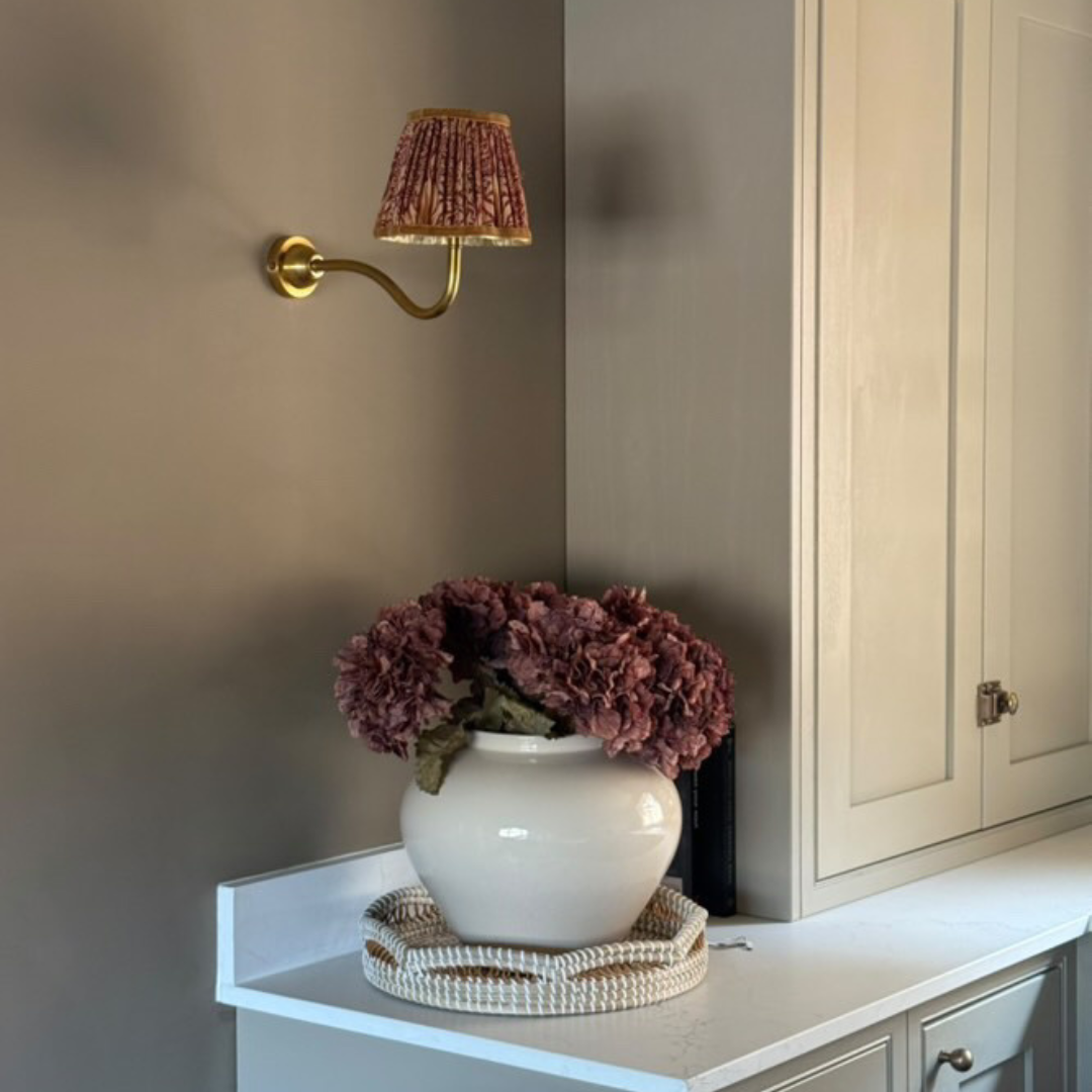 Faux dried mocha hydrangea stem in white ceramic vase on kitchen worktop