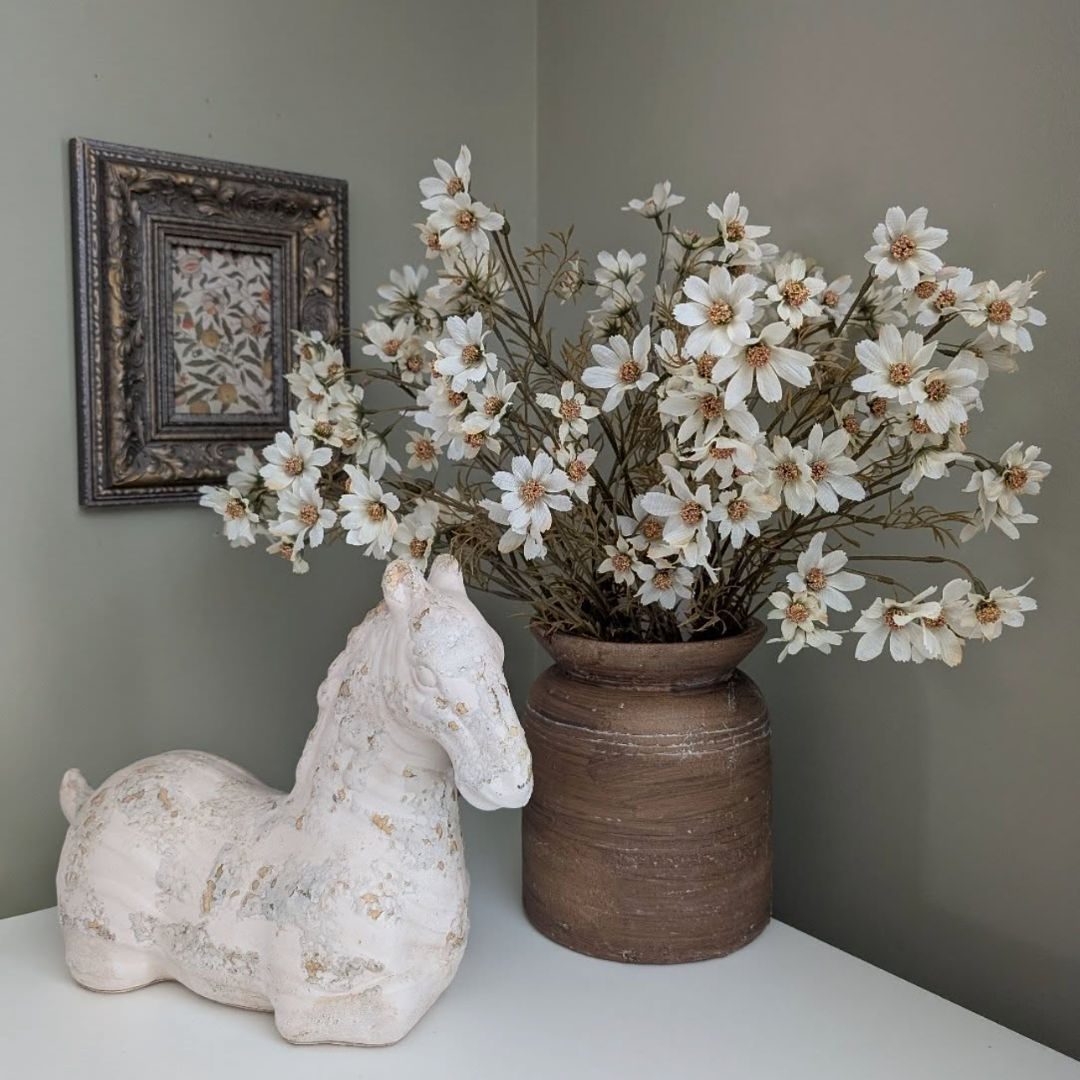 small rustic brown vase with dried cosmos flowers