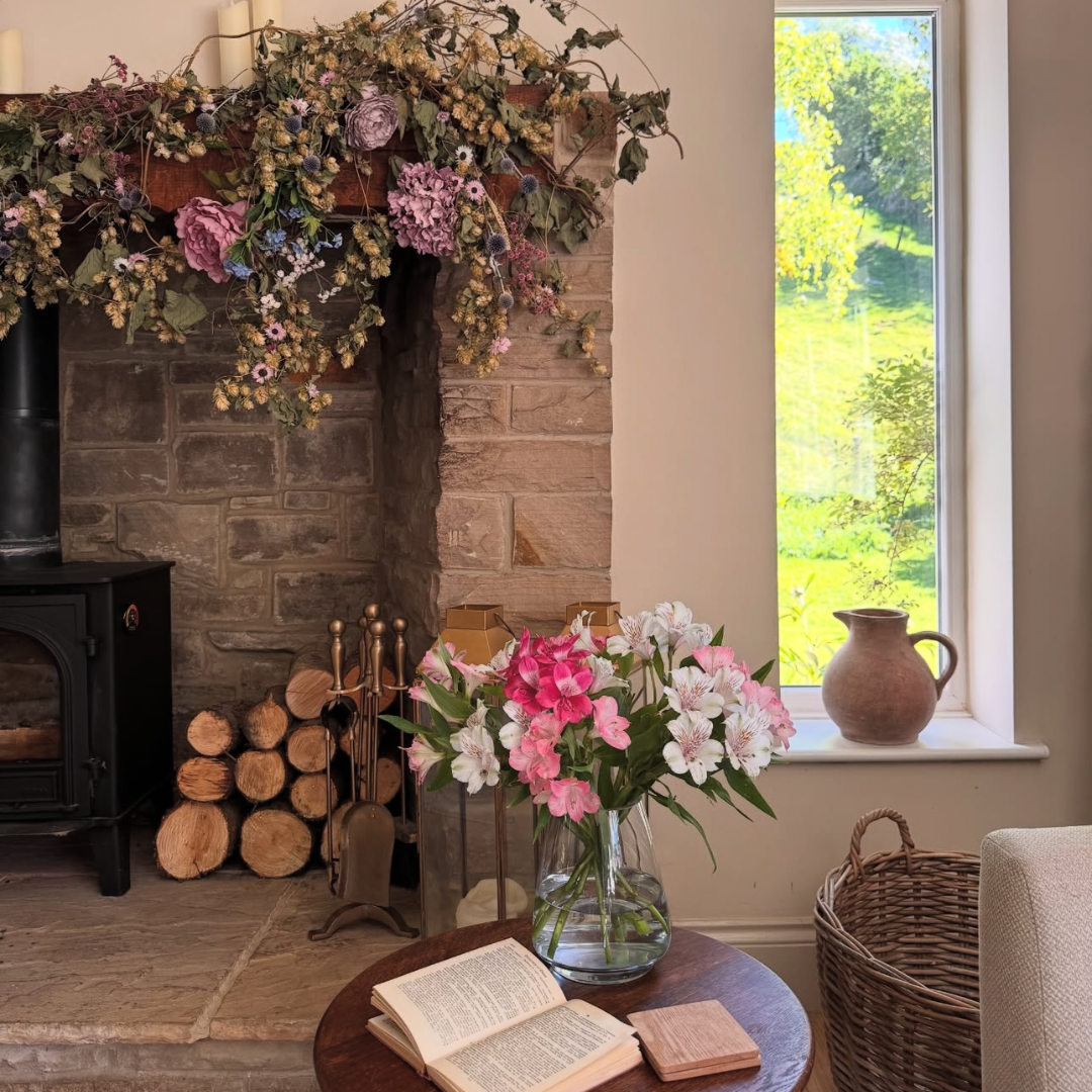rustic brown jug in country style living room with hops garland
