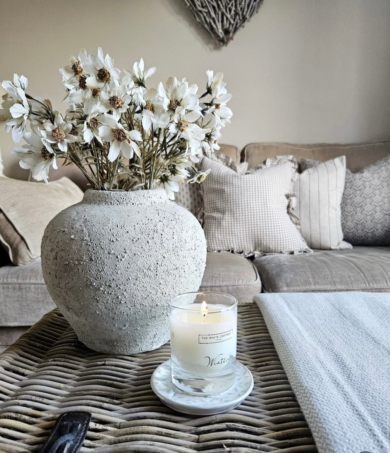 rustic stone effect vase filled wth faux cream cosmos stems, beautiful styling idea for home decor