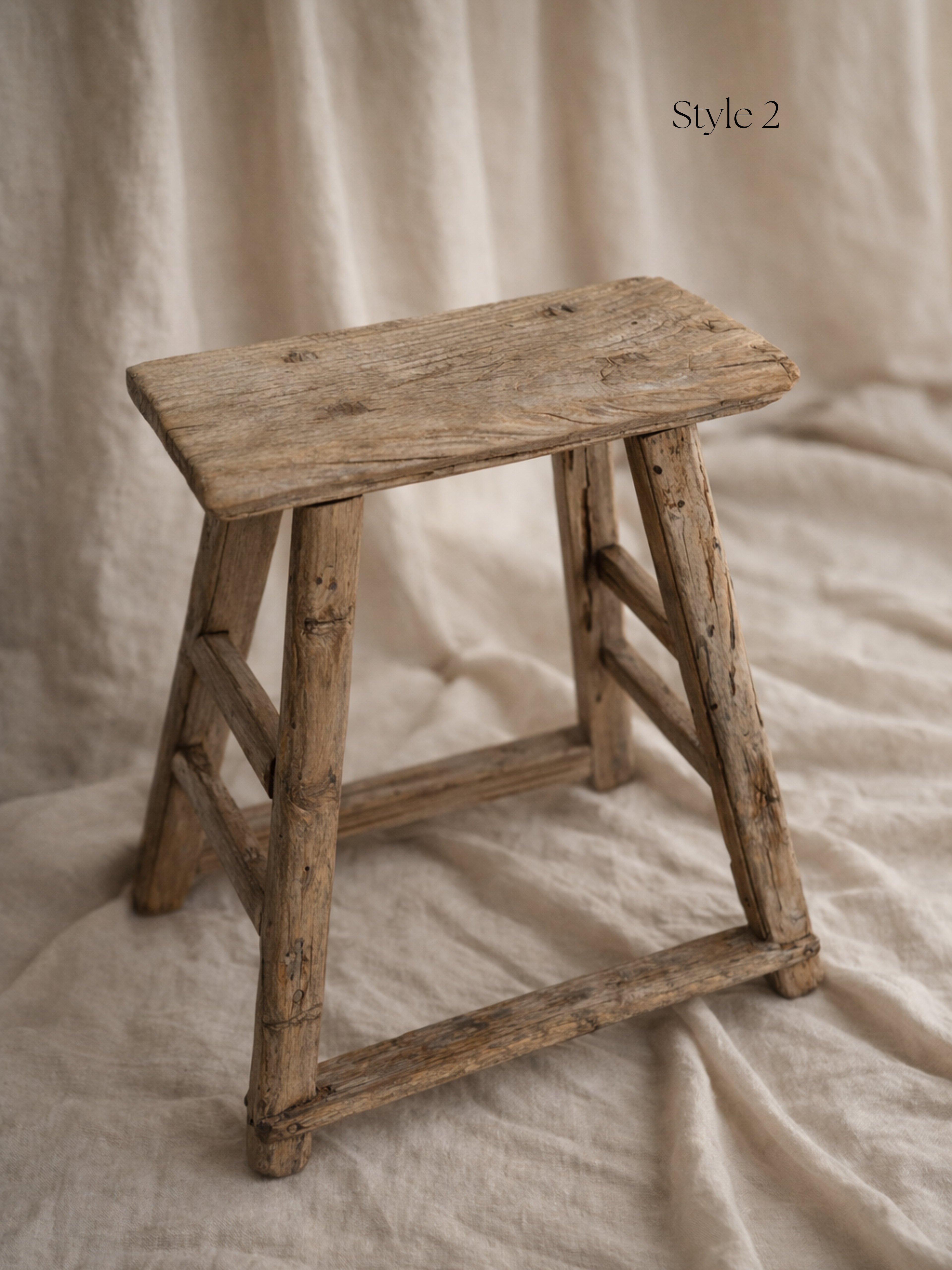 Vintage wooden stool on a beige fabric background for home decor