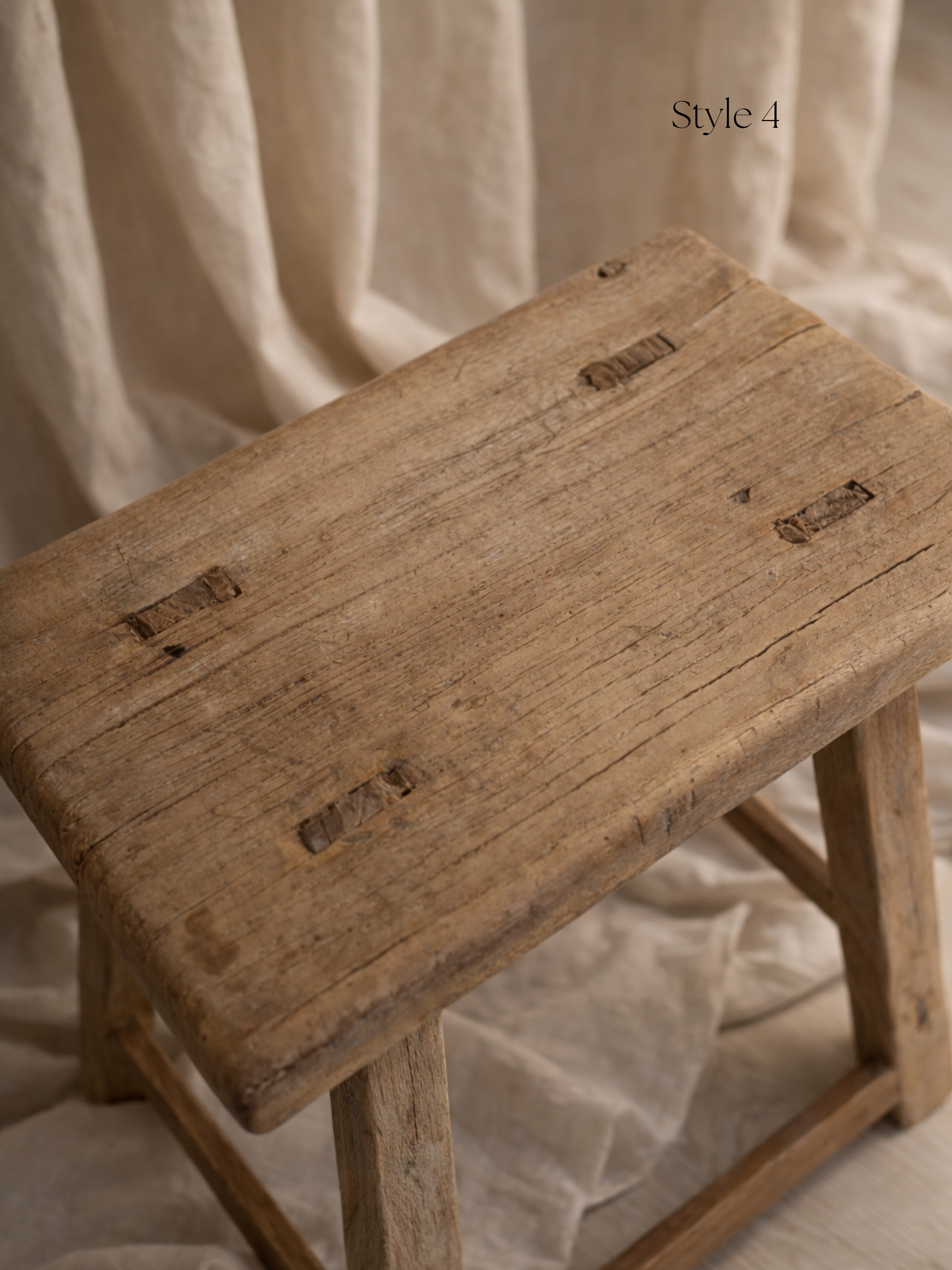 Vintage wooden stool with a textured surface on a neutral background for home decor
