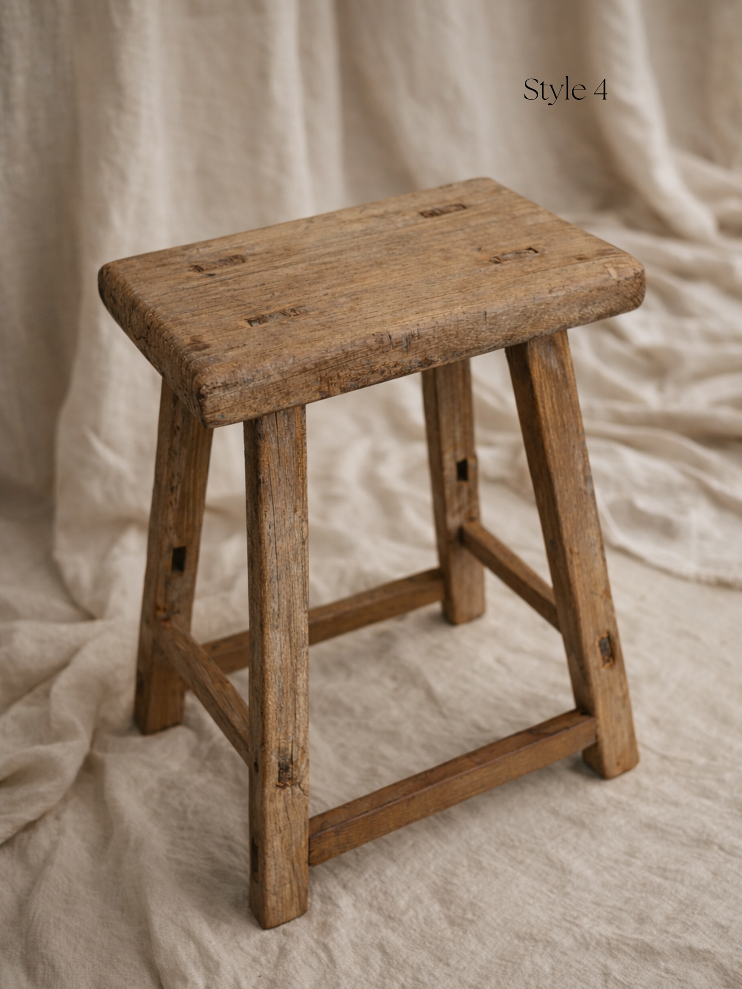 Vintage wooden stool on a textured beige background for home decor
