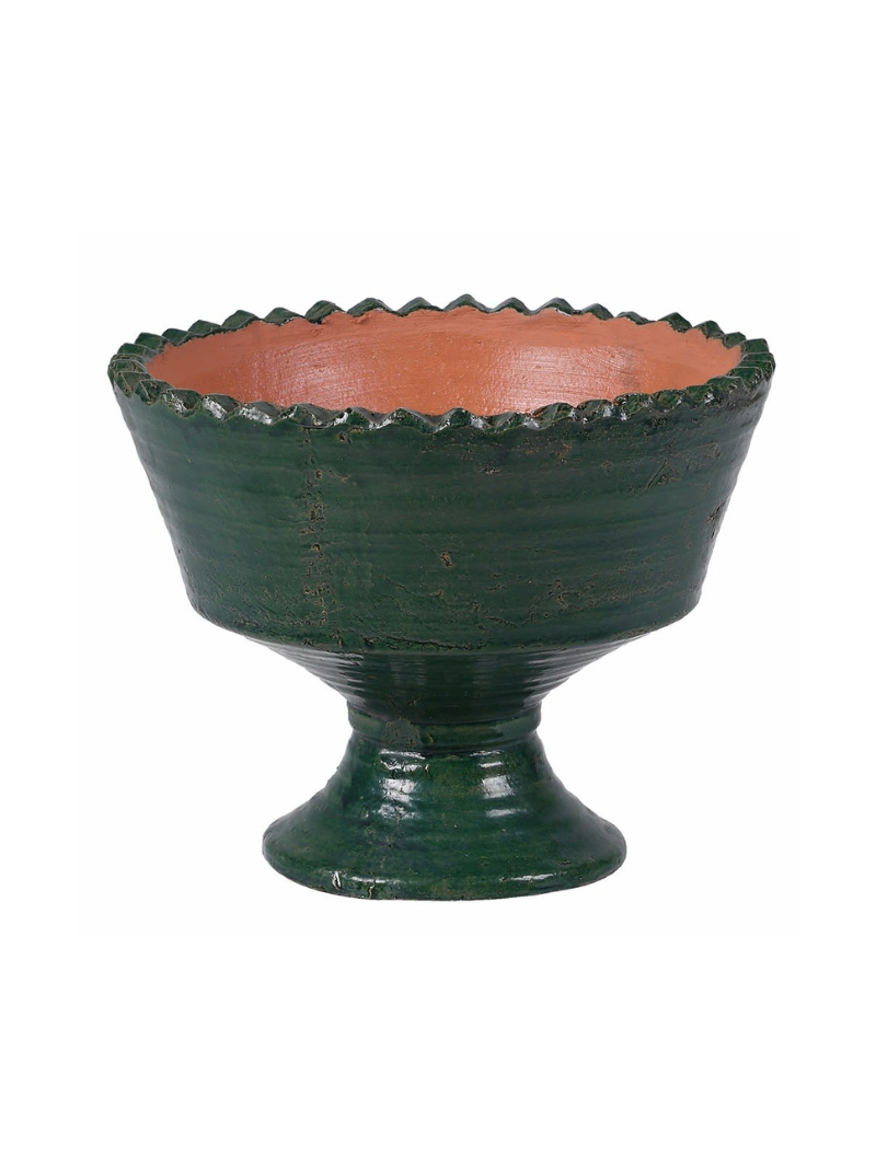 Decorative bowl with green exterior and terracotta interior on a white background