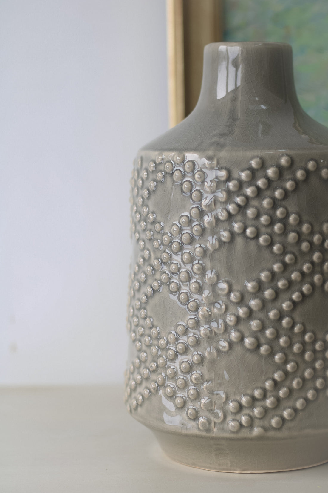 up close of grey ceramic dotty vase