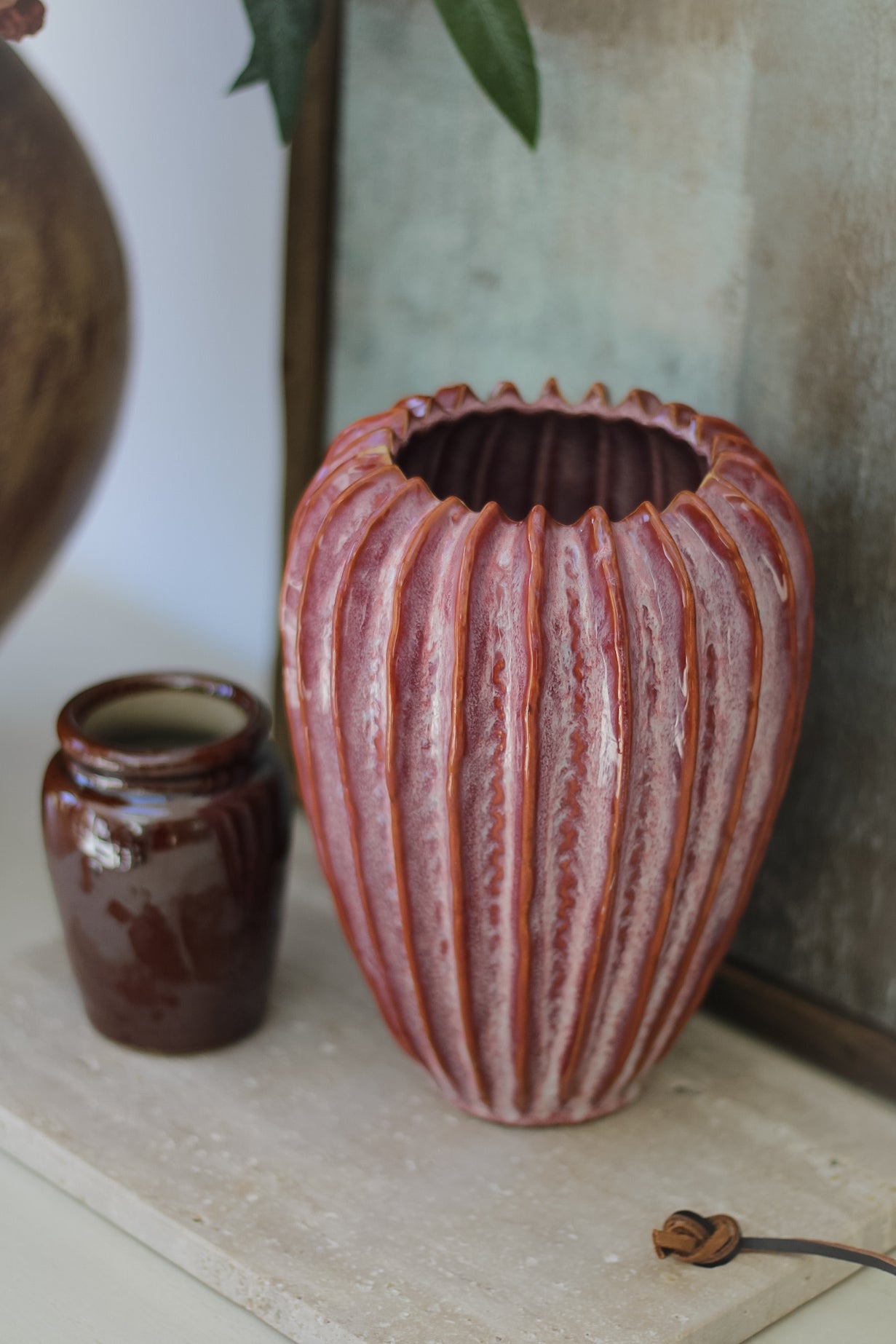 ceramic vase with ridge details in raspberry pink tones