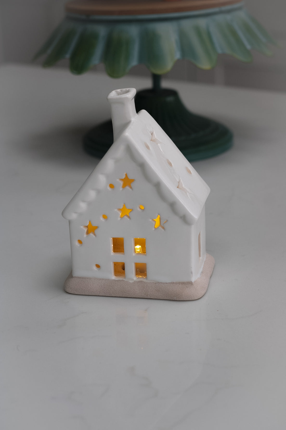white ceramic house with star cut outs