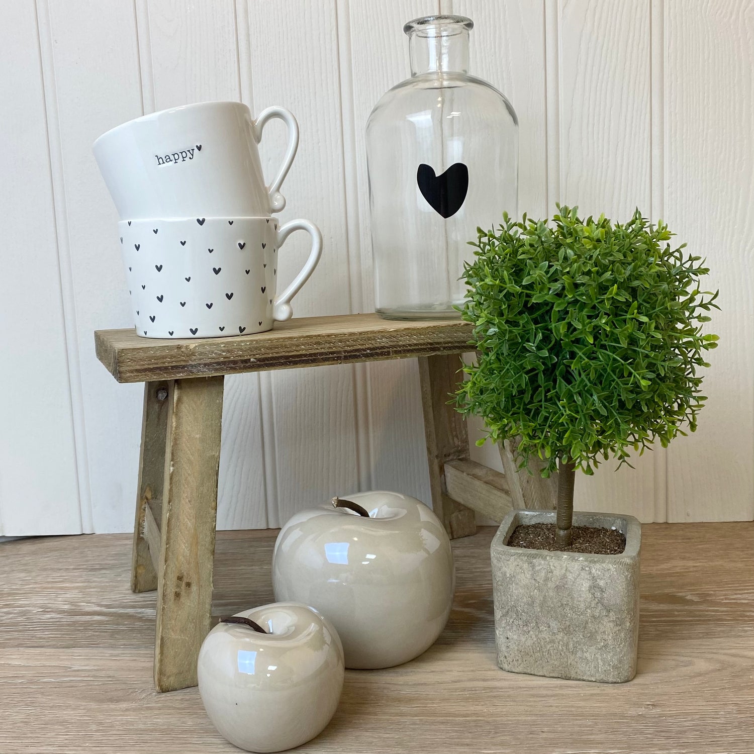 styled small wooden bench with green plant