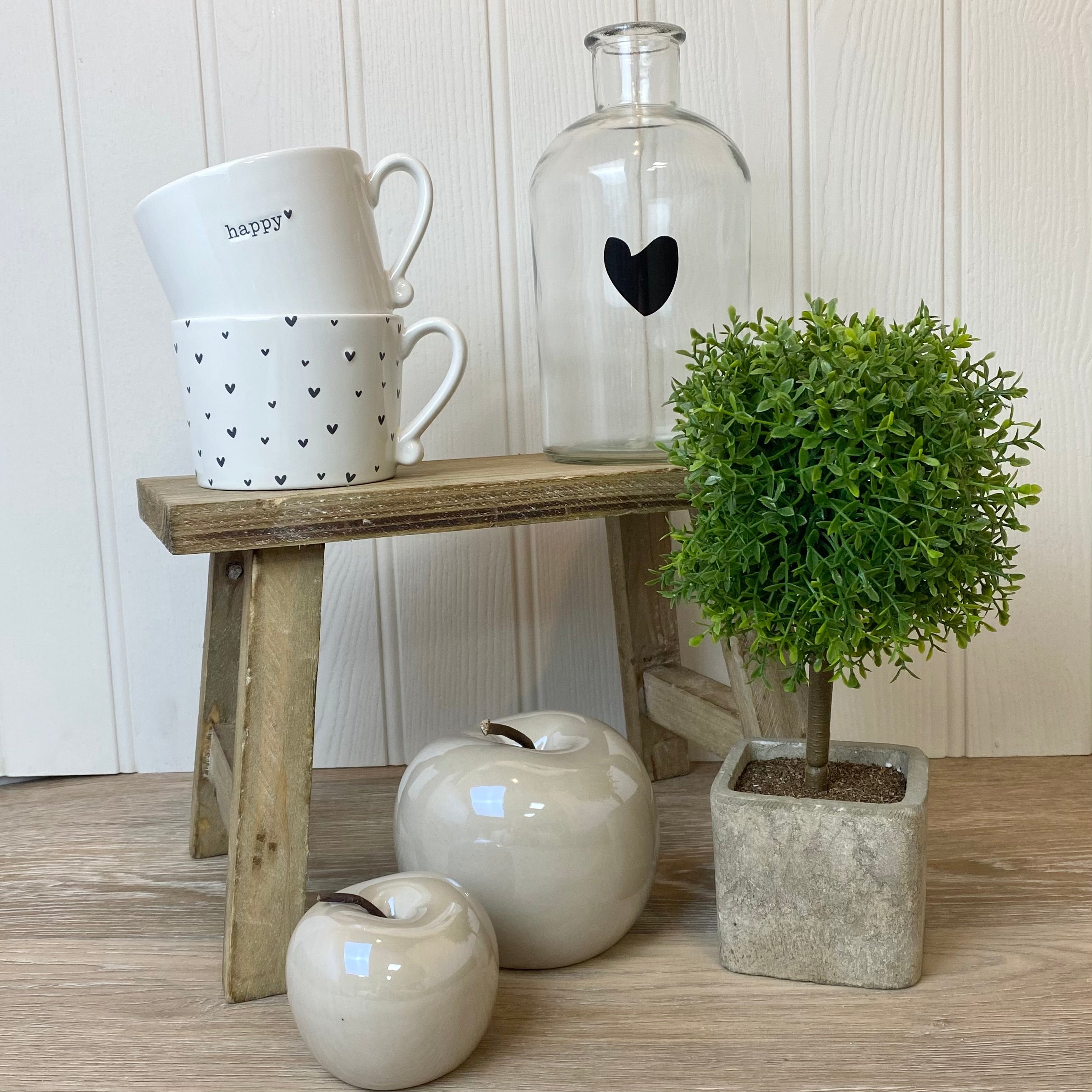 styled small wooden bench with green plant