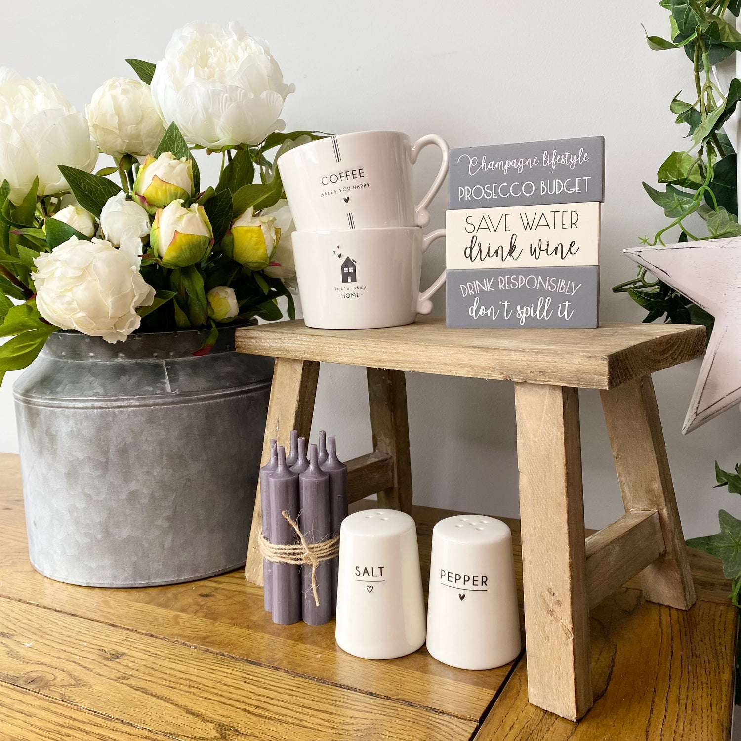wooden bench on worktop with mugs and salt and pepper